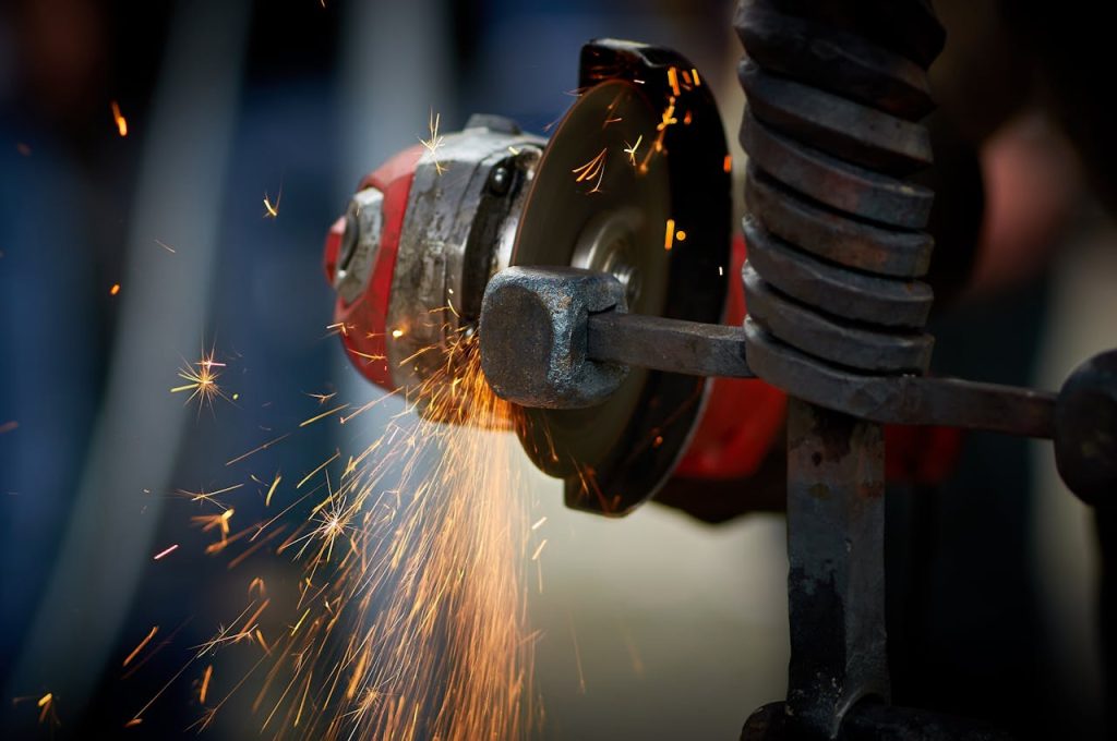 sparkles-from-grinder-15628889 Dynamic close-up of an angle grinder in action, emitting bright sparks as it shapes metal.